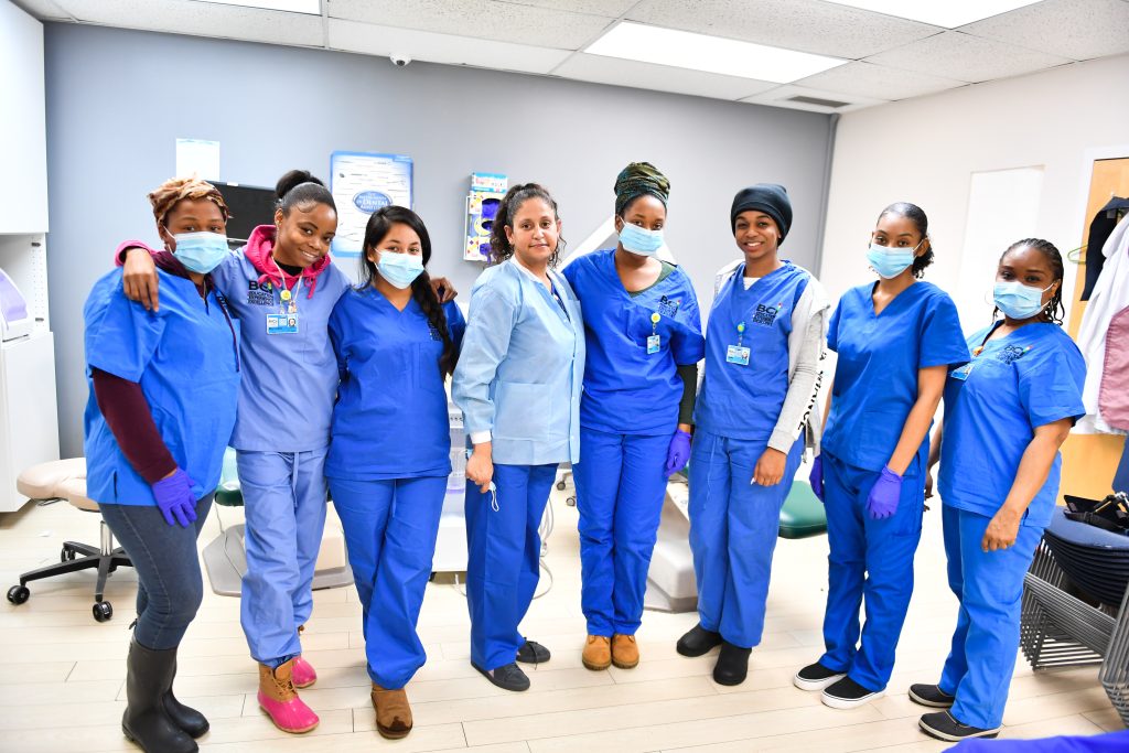Group of diverse healthcare workers in scrubs and masks